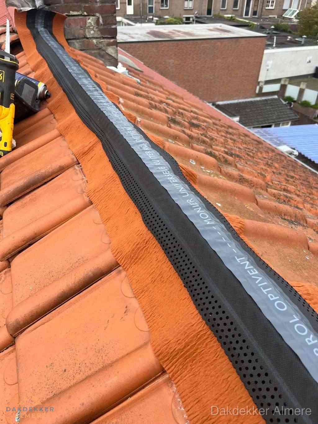 Plat dak aanbouw met bitumen naast schuin pannendak in Almere